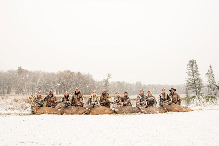 Group of people with trophies in the snow